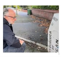 Man looking at sign reading, "City Borough of Wigan".