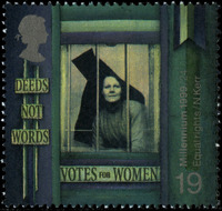 Green stamp with suffragette looking out of broken prison window. Text reads, "deeds not words" and "votes for women".