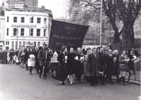 Black and white photograph of strikers parade. They carry a banner reading, "union of post office workers Bristol Branch".
