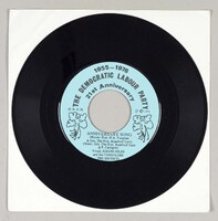 The vinyl has a light blue label with two Dwarf Poinciana flowers on the side, which is the national flower of Barbados. The text says: '1955-1976, The Democratic Labour Party, 21st Anniversary, Anniversary song (Words: Honourable H.A. Vaughan & Senator The Honourable Brandford Taitt and P. Castagne), Vocal: Joseph Niles and the Consolers, the Escorts.