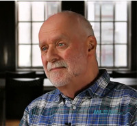 Headshot of a man looking to the side of the camera.