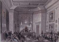 Meeting of the Society of Antiquaries at Somerset House, engraved by H S Melville from the drawing by F W Fairholt. The image shows numerous objects that can now be found in Burlington House, including one of the chandeliers now on the ground floor, some of the paintings now in the Meeting Room and along the main stairs, and the marble bust of George III.