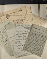 A pile of handwritten letters laid out and photographed from directly above.