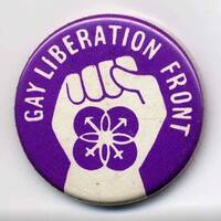 Purple badge with fist pointing upwards and text reading, "gay liberation front".