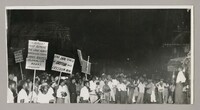 The photograph captures a crowd of people holding up protest signs with a speaker addressing them to the right. The slogans include 'End 300 years of British rule - freedom now!', 'Government must remove the laws against workers trade union rights' and 'Colonialism means poverty'.