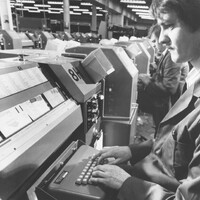 Interior close-up view of a male operative in front of a coding desk.