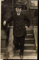 A smartly dressed George Lansbury stood on steps for a photo.