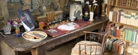 Vita Sackville-West's desk at Sissinghurst Castle Garden with photos of Virginia Woolf and Harold Nicholson | © National Trust Images/Jonathan Buckley